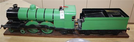 A 3.5 inch gauge 4-4-2 live steam locomotive and tender on wood stand, loco 27in. tender 18in.